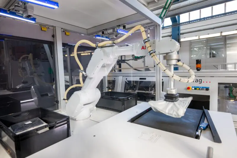 ABB pick robot performing automated pick station integration with a ferag.skyfall induct station